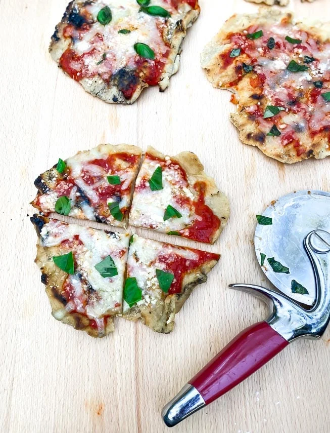 Top Low FODMAP Labor Day Grill Recipes - 7-Low FODMAP Grilled Pizza-vertical-image-grilled-pizza-on-board-with-cutter